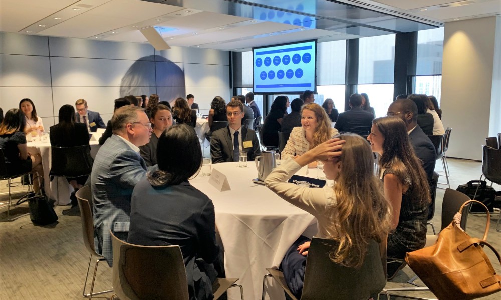 A Torys lawyer speaking to a table of students.