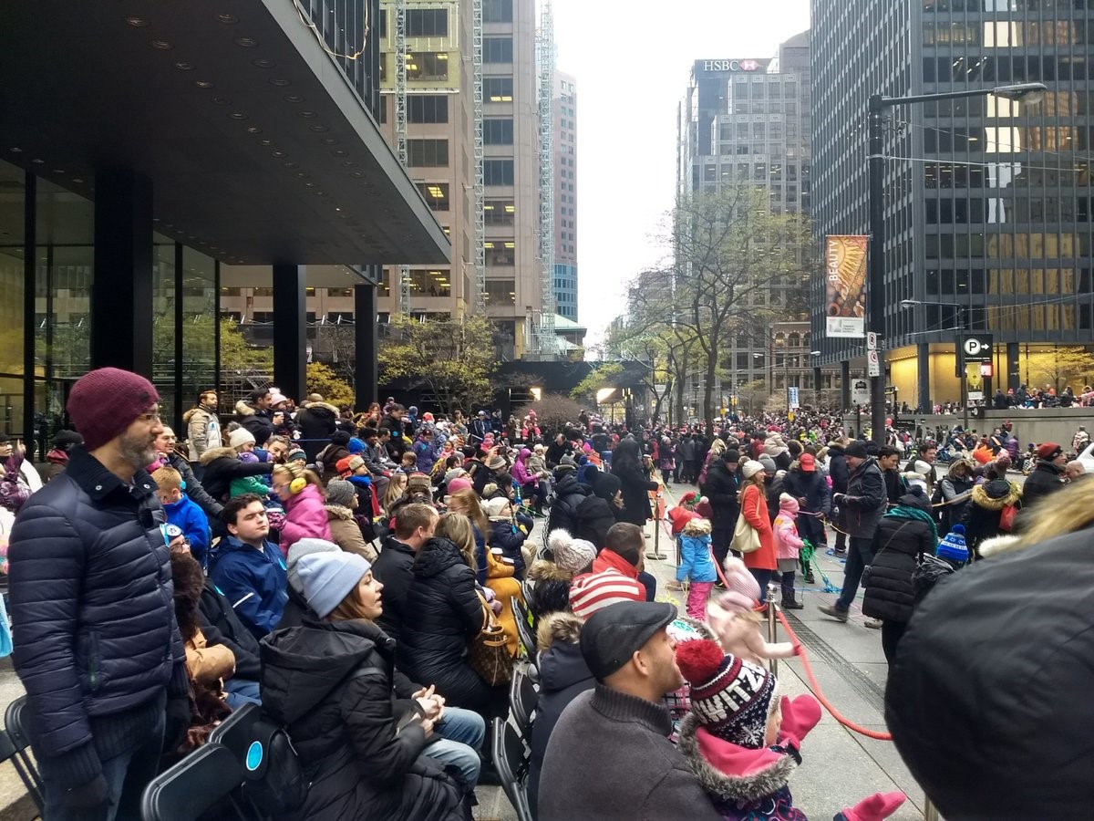 A crowd on Wellington Street West awaits the arrival of Santa Claus.