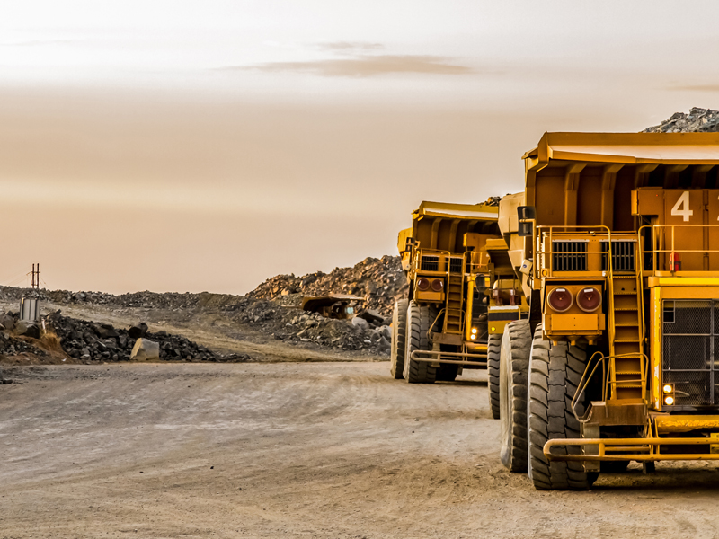 Mining trucks sitting idle at a mine site.